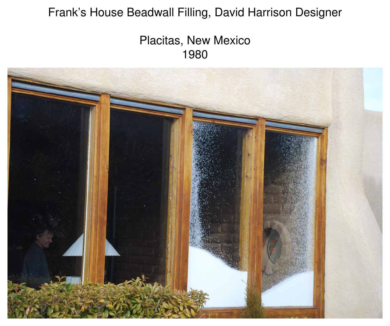 Photograph of Frank's House Beadwall windows being filled with white insulating beads between the glazing panes, Placitas, NM, 1980