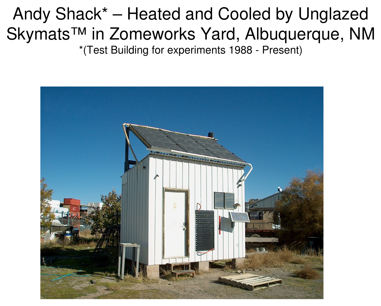 Exterior photograph of the Andy Shack test building with a rooftop panel, in the Zomeworks yard, Albuquerque, NM