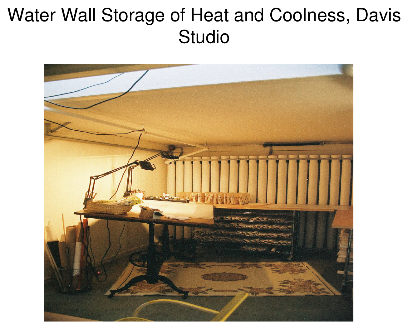 Interior photograph of water-wall storage of heat and coolness in the Davis studio