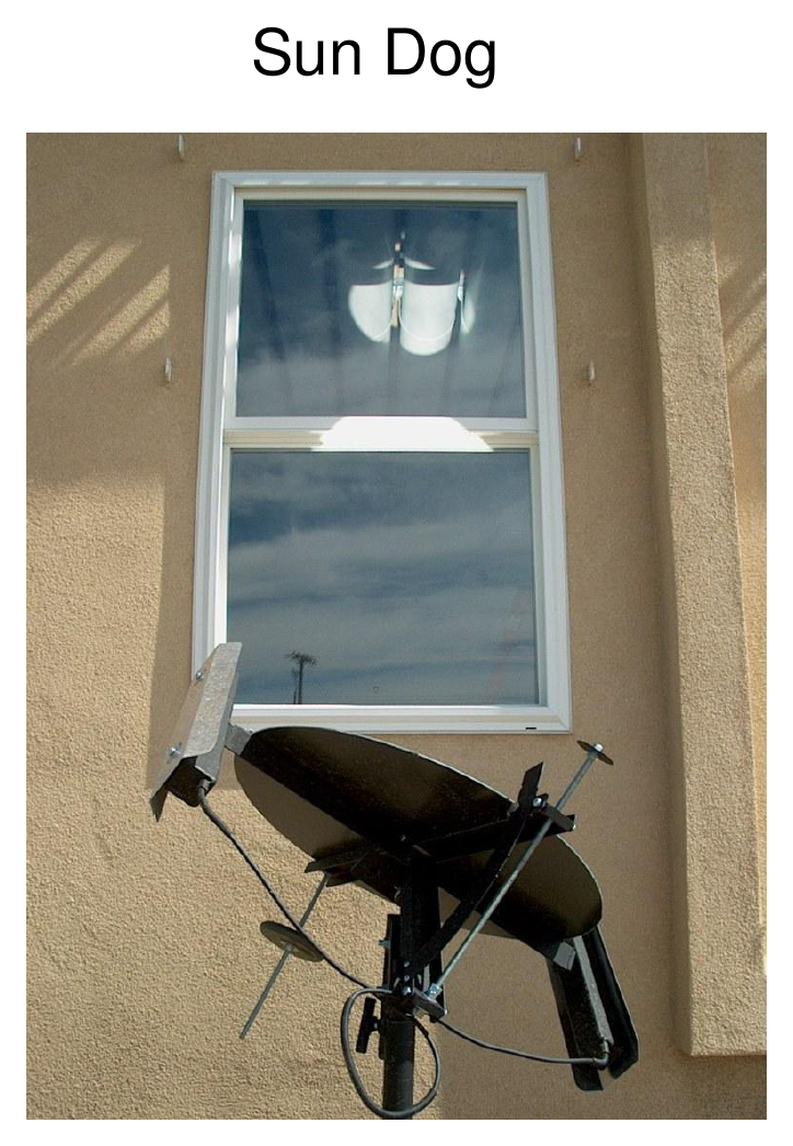 Photograph of the Sun Dog daylighting device — a curved reflector on a stand below a window